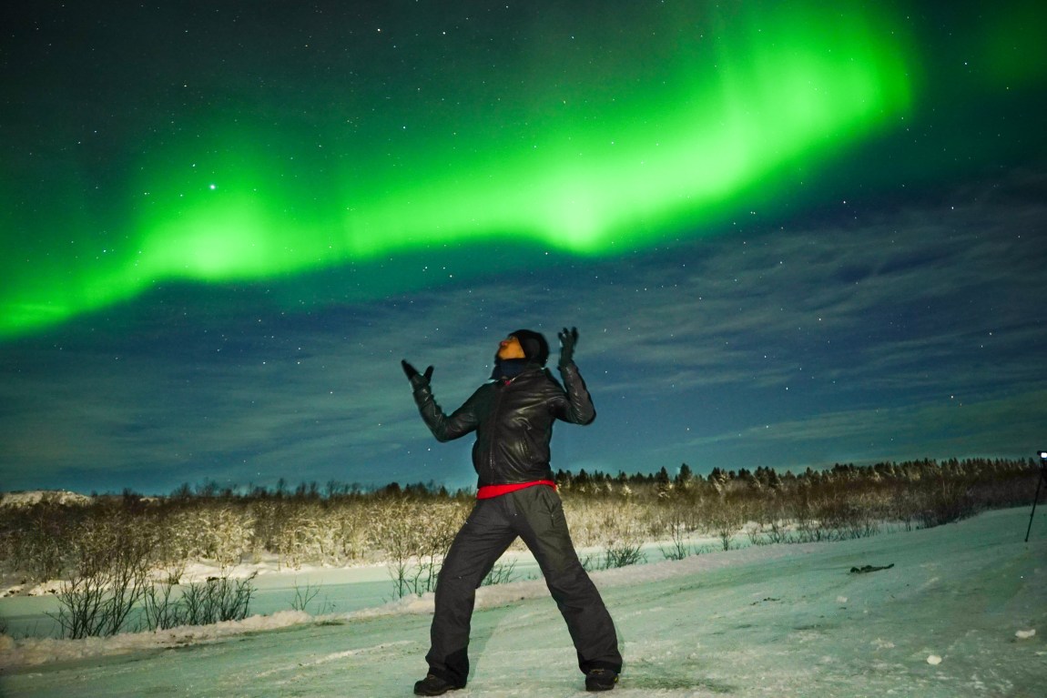 a guy enjoying the dancing light in northern russia