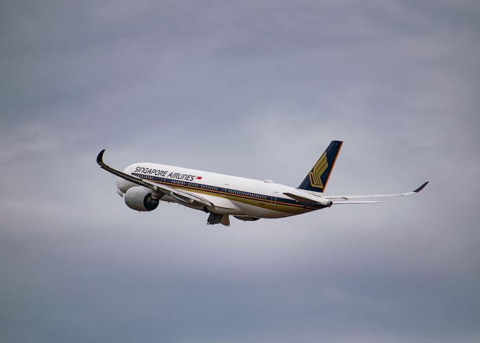 Aeroplane flying high in the sky with cloudy background: flight traveling to russia