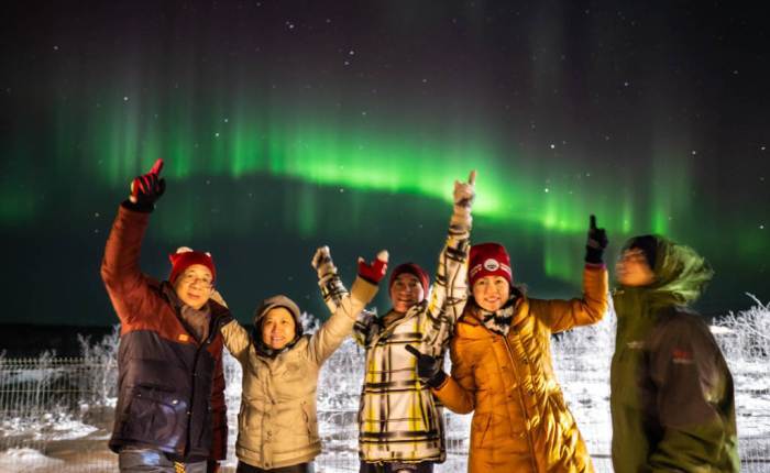 group photo under aurora borealis