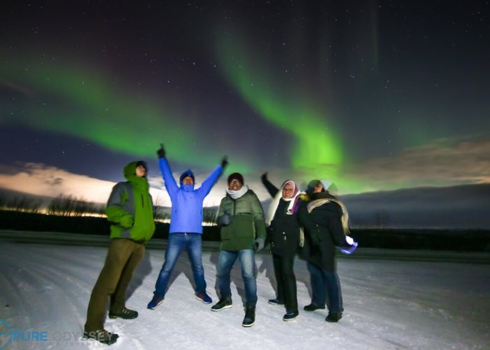 Group photo under the dancing Northern Light